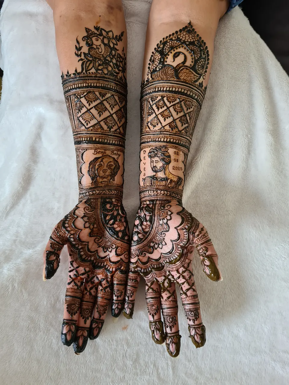 Full-arm bridal mehndi featuring hand-drawn bride and groom portraits